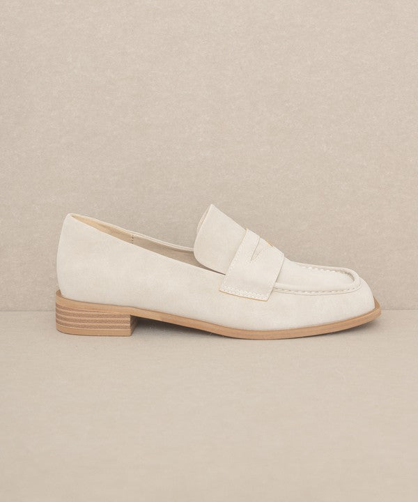 Introducing June Square Toe Penny Loafers, a timeless blend of sophistication and comfort. Crafted with precision, these loafers feature a sleek square toe design that effortlessly merges classic style with contemporary flair. The genuine leather construction ensures durability, while the penny strap adds a touch of refined detail.
