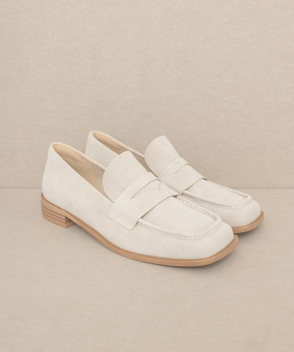 Introducing June Square Toe Penny Loafers, a timeless blend of sophistication and comfort. Crafted with precision, these loafers feature a sleek square toe design that effortlessly merges classic style with contemporary flair. The genuine leather construction ensures durability, while the penny strap adds a touch of refined detail.