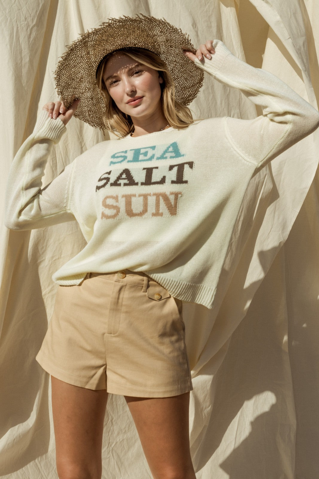 Capture the essence of coastal charm with our Sea Salt Sun Sweater. This sweater exudes relaxed elegance with its round neckline and long sleeves, perfect for cool days by the sea or cozy evenings at home.
