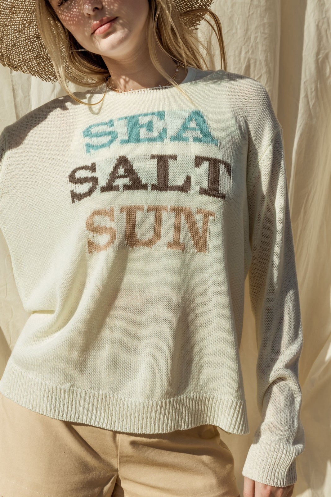 Capture the essence of coastal charm with our Sea Salt Sun Sweater. This sweater exudes relaxed elegance with its round neckline and long sleeves, perfect for cool days by the sea or cozy evenings at home.