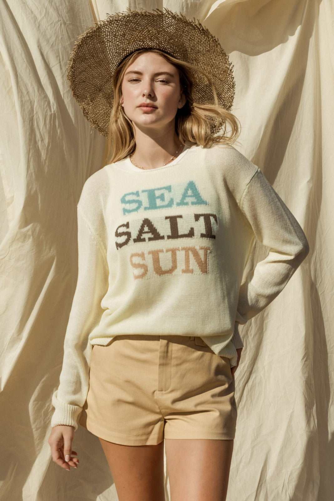 Capture the essence of coastal charm with our Sea Salt Sun Sweater. This sweater exudes relaxed elegance with its round neckline and long sleeves, perfect for cool days by the sea or cozy evenings at home.