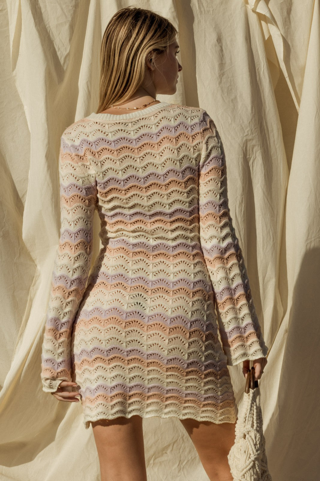 Introducing our Penelope Bell Sleeve Sweater Dress, a chic and stylish for your summer beach wardrobe. This dress features a classic round neckline and elegant bell sleeves, adding a touch of flair to your ensemble. Perfect for chilly nights by the beach or just a coverup for after your swim. 