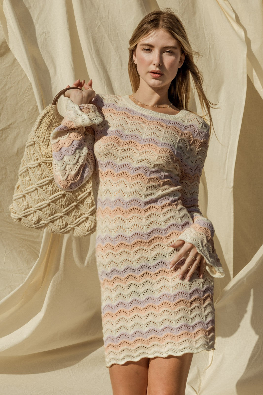 Introducing our Penelope Bell Sleeve Sweater Dress, a chic and stylish for your summer beach wardrobe. This dress features a classic round neckline and elegant bell sleeves, adding a touch of flair to your ensemble. Perfect for chilly nights by the beach or just a coverup for after your swim. 
