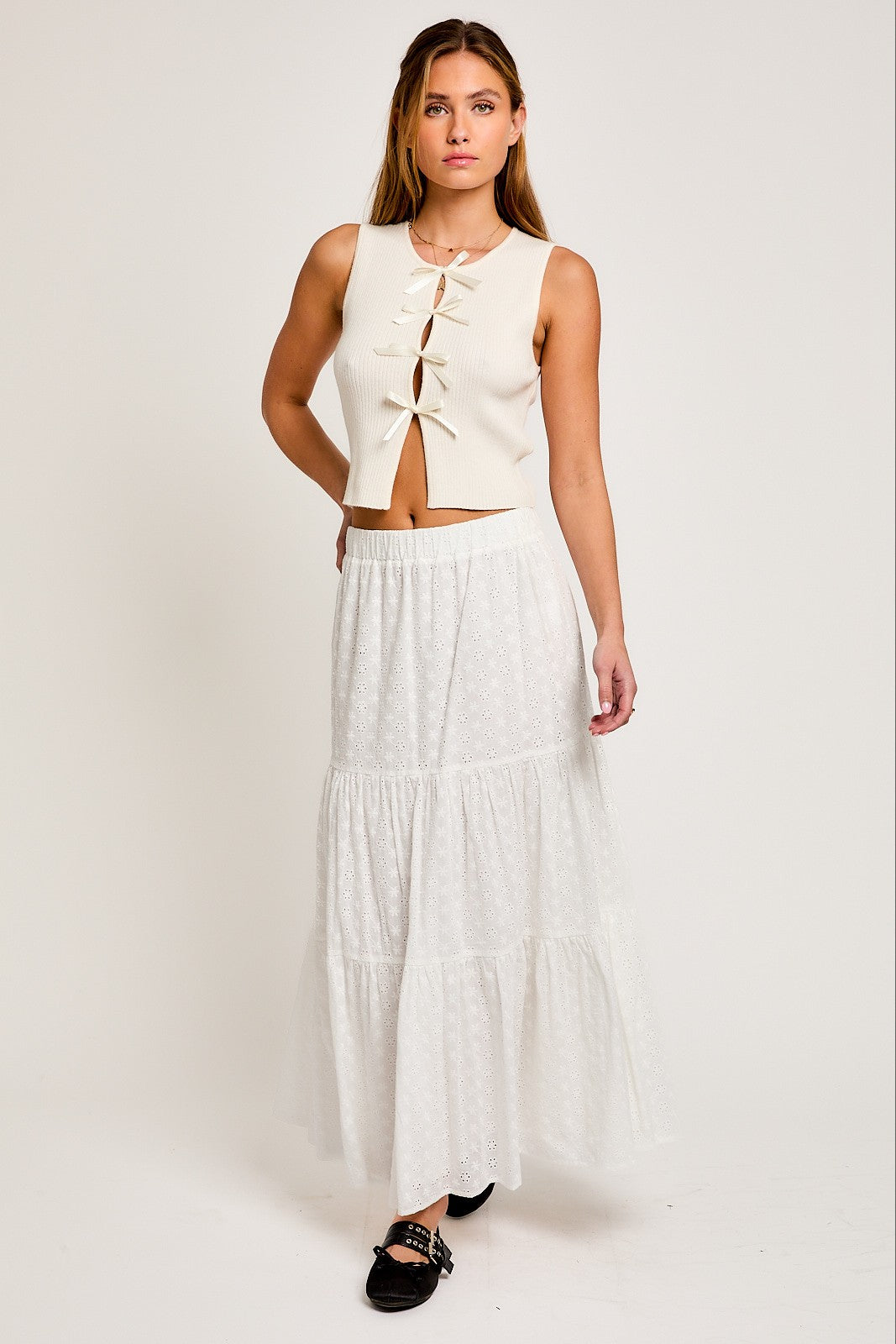 Add elegance to your style with this chic Satin Bow Sleeveless Sweater Top. Made from a soft, lightweight knit, this top has a classic sleeveless design and a feminine satin bow on the front. Perfect for any occasion, pair it with skirts, trousers, or jeans for a stylish and versatile look.