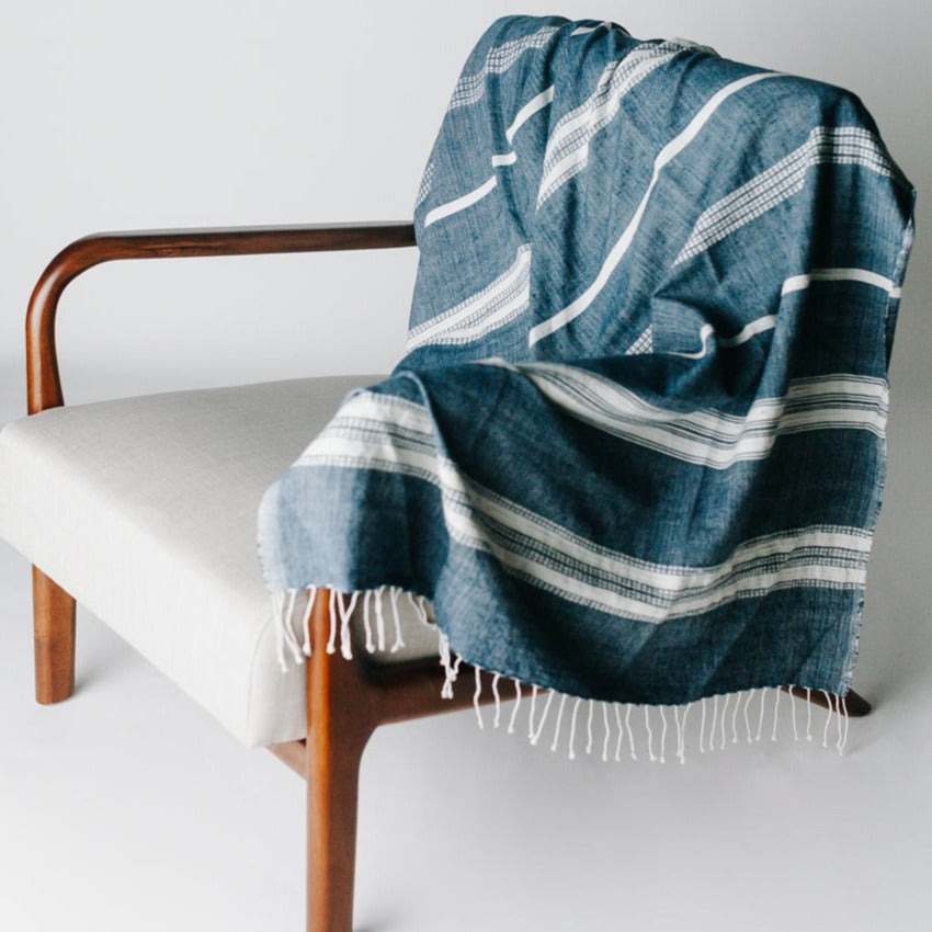 Lightweight and super-soft, this is easily the most versatile home textile ever. Its size works perfectly as a cozy wrap or decorative throw and our signature Aden striped design compliments any decor. And did we mention it's also the perfect travel accessory? Hand-spun Ethiopian cotton adds a uniquely rich texture that will continue to soften and become more absorbent with each wash/dry.
Measures 38 x 72 inches. Ethically crafted in Ethiopia.