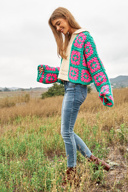 Introducing our Two-Tone Floral Square Crochet Open Knit Cardigan-a bohemian-inspired masterpiece that seamlessly blends style and craftsmanship. This cardigan showcases a captivating two-tone color palette and features a square crochet open knit design adorned with intricate floral patterns.