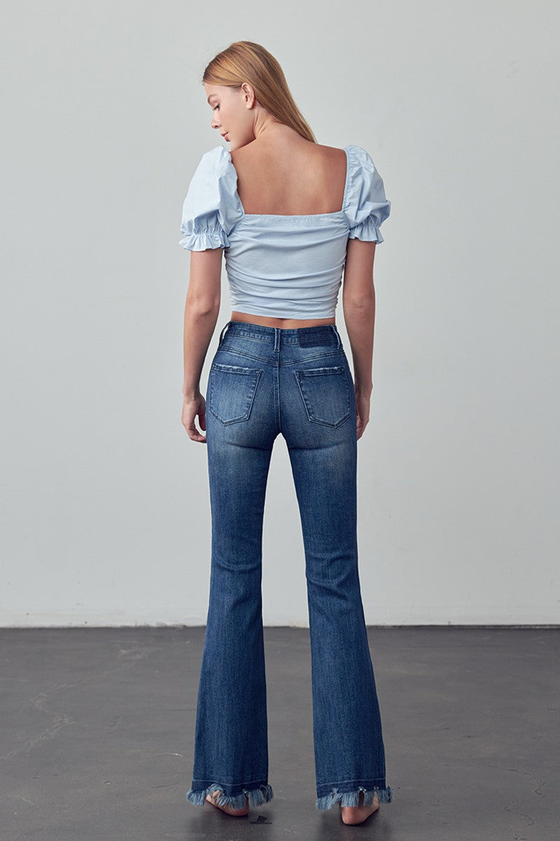 Crafted for those who crave comfort and style, the Emily Frayed Hem Flare Jeans have got you covered! Made from stretch denim for the perfect fit, their frayed hem adds a touch of edge. And let's not forget the pockets - because who doesn't love a functional detail? Designed with love in the USA. Model is 5'9" and is wearing a size 3  Garment measurements for size 3 Waist: 25 1/2", Hip 32 1/2", Front Rise 10", Leg Opening 21 1/2", Inseam 33"