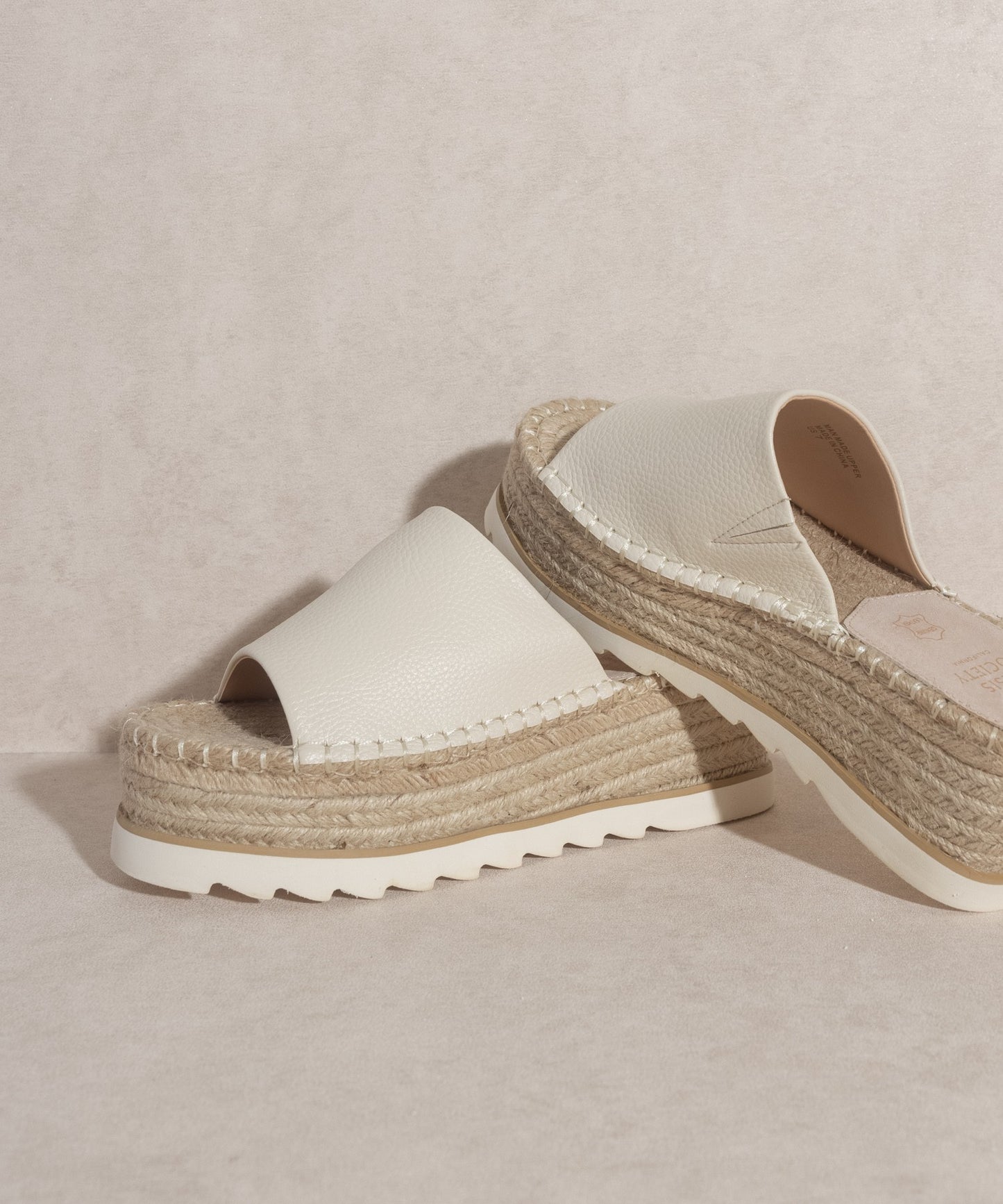 Walk with grace and style in the Ivy Espadrille Platform Slide. The perfect casual and comfortability footwear. With its unique platform design and handcrafted construction, the Ivy Espadrille Platform Slide provides unmatched support and a luxurious feel with each step. Say goodbye to sacrificing comfort for style and experience true luxury with these slides.