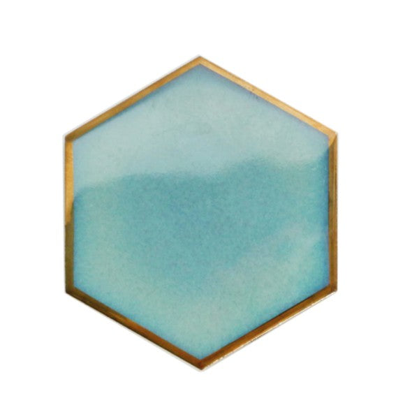 Unleash your inner creativity and add a touch of sophistication with this set of four hexagonal coasters, accented with gold edges and suede lining. Use them individually or combine them to create a heat-resistant base for hot dishes. Available in black, blue, and aqua, the possibilities are endless.  Ceramic Diameter: 4" Thermal insulation Set includes 4 pieces