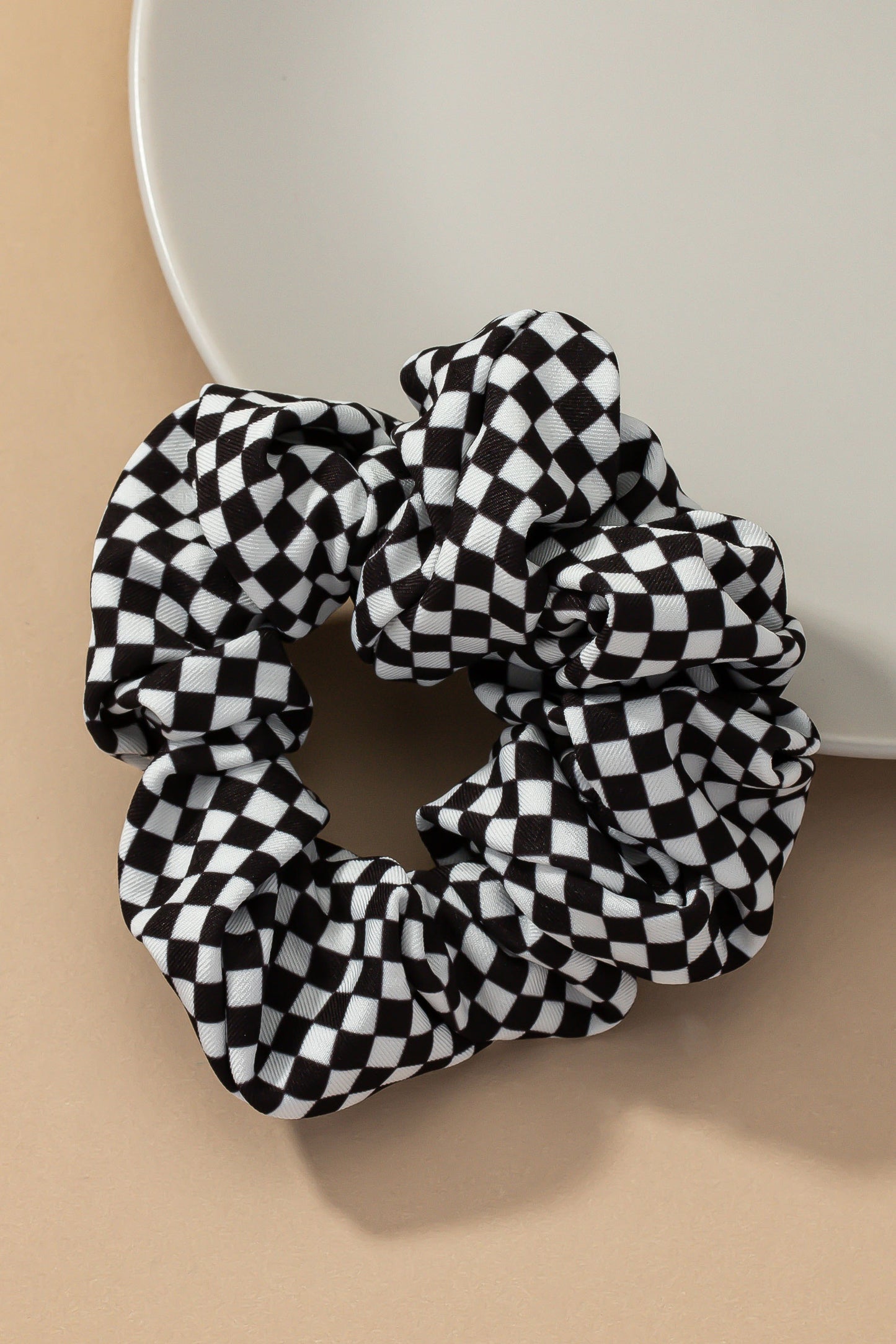 Upgrade your hair accessory collection with the Checker Satin Scrunchies. With its soft satin materials, these scrunchies are gentle on your hair, minimizing breakage and ensuring a comfortable hold.