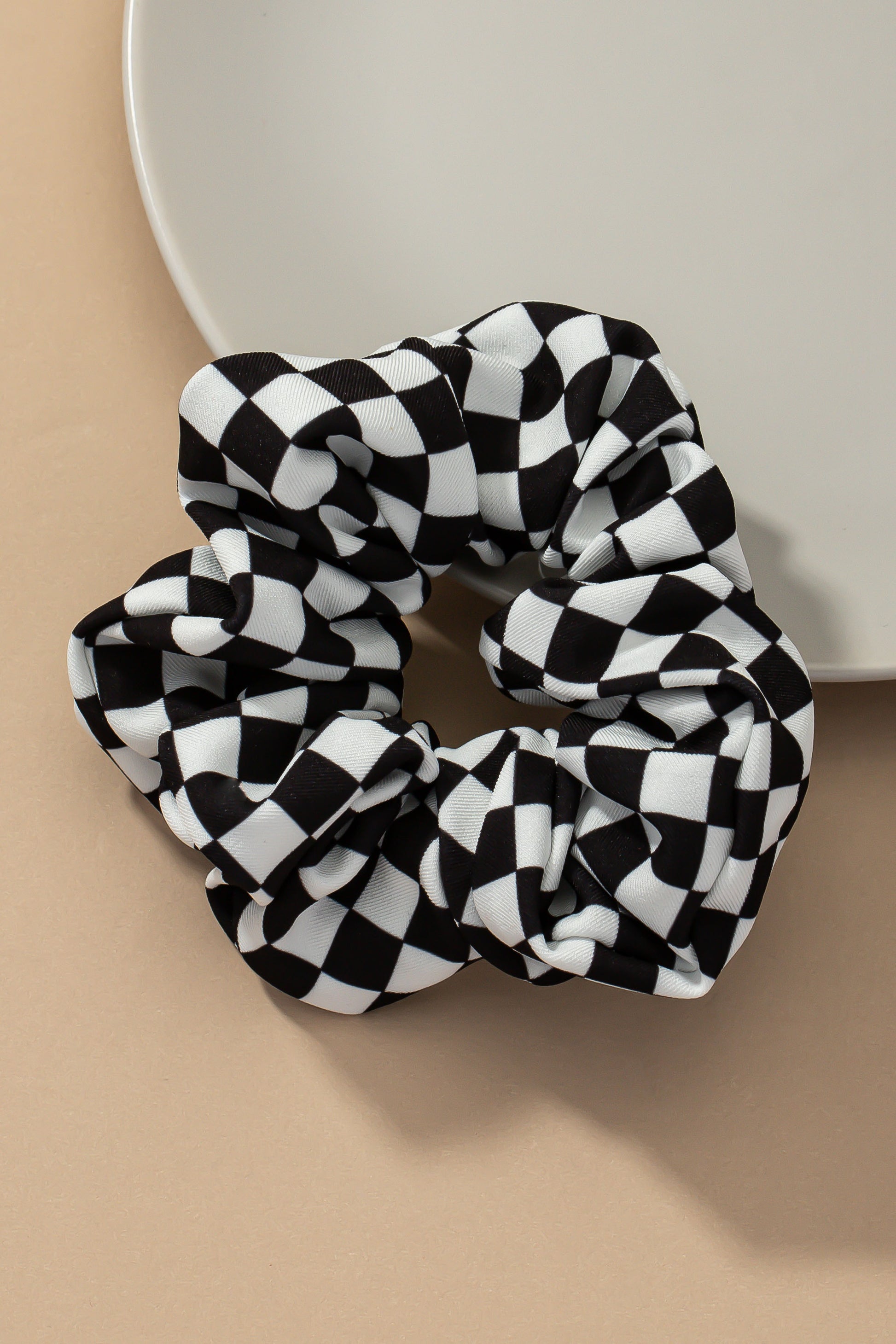 Upgrade your hair accessory collection with the Checker Satin Scrunchies. With its soft satin materials, these scrunchies are gentle on your hair, minimizing breakage and ensuring a comfortable hold.