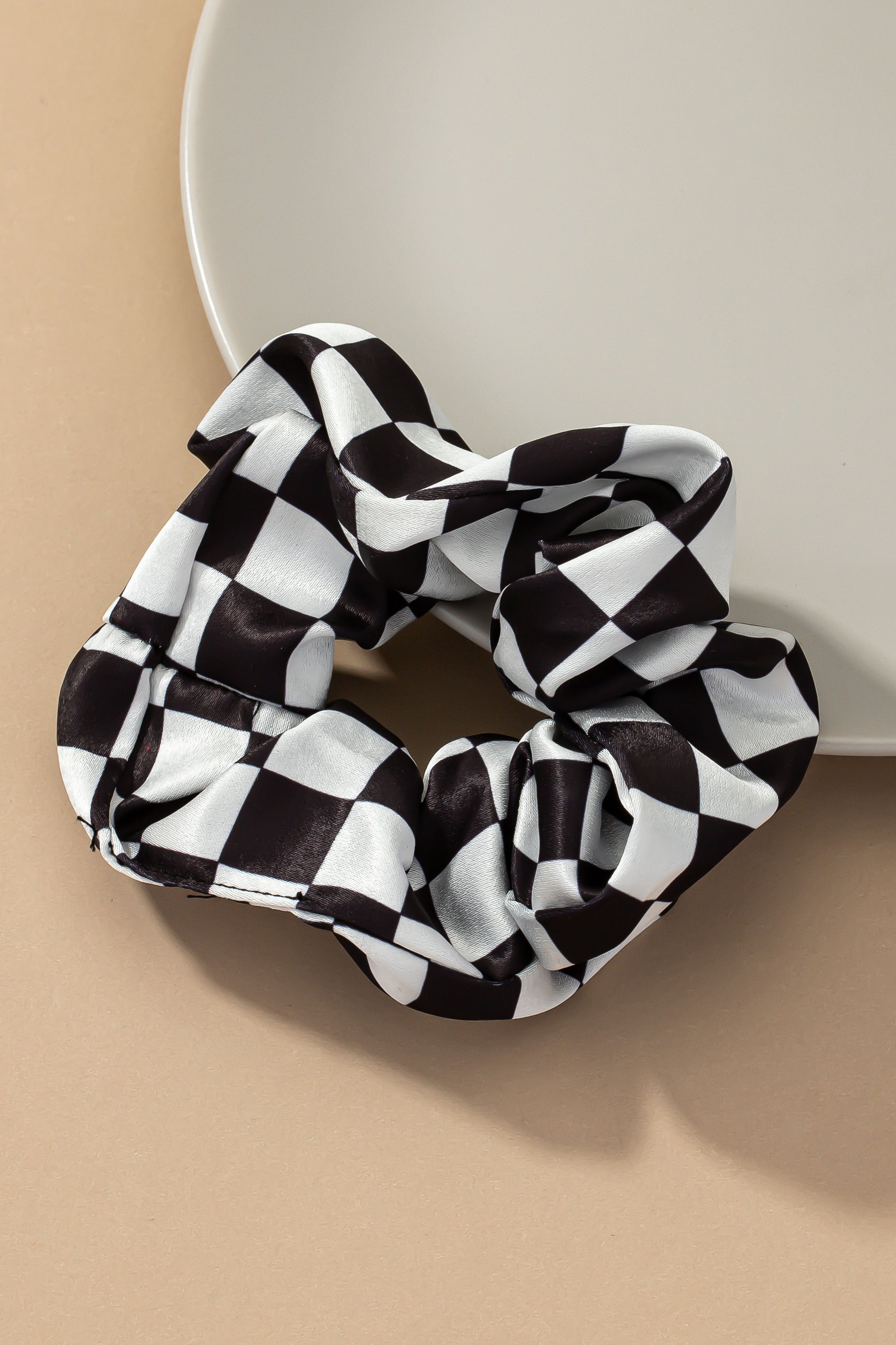 Upgrade your hair accessory collection with the Checker Satin Scrunchies. With its soft satin materials, these scrunchies are gentle on your hair, minimizing breakage and ensuring a comfortable hold.