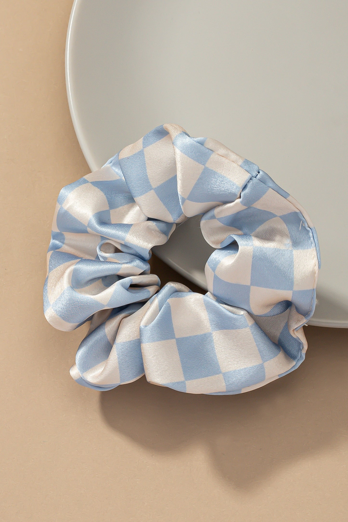 Upgrade your hair accessory collection with the Checker Satin Scrunchies. With its soft satin materials, these scrunchies are gentle on your hair, minimizing breakage and ensuring a comfortable hold.