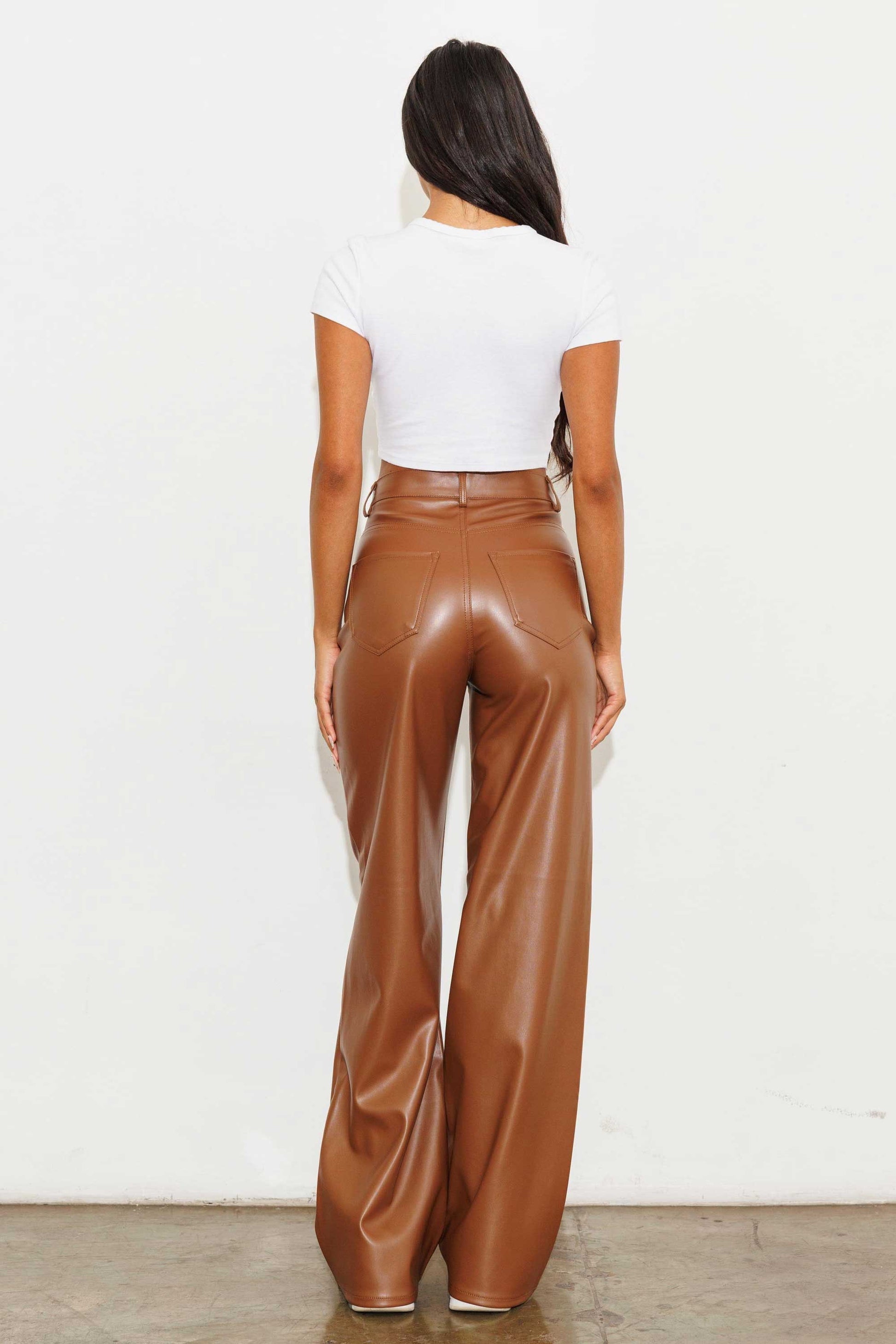 Unleash your stylish side with the Charlotte Vegan Leather Wide Leg Pants! Made from top-quality PU, these pants are both chic and ethical. With front and back pockets for convenience, plus a sleek zip-fly closure, these pants are a must-have for any fashion-forward wardrobe.  Model is 5'8" and wearing a size 3