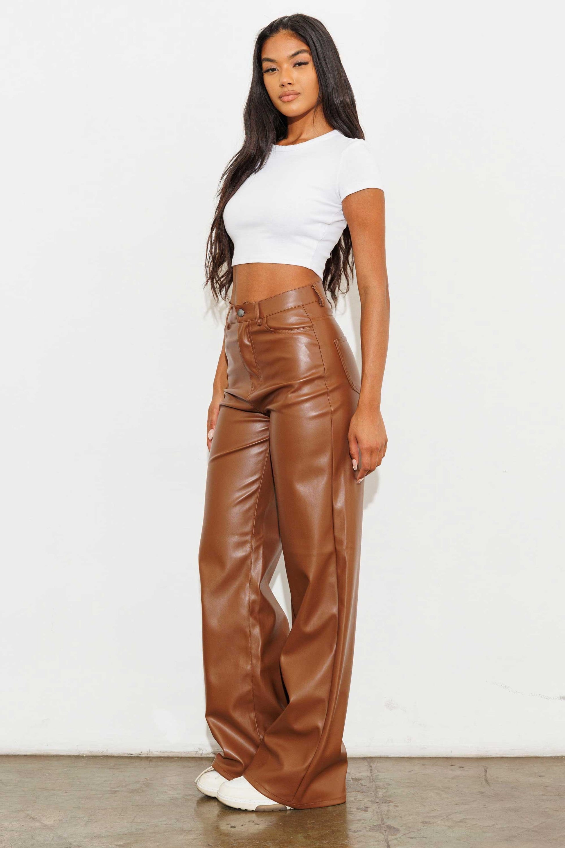 Unleash your stylish side with the Charlotte Vegan Leather Wide Leg Pants! Made from top-quality PU, these pants are both chic and ethical. With front and back pockets for convenience, plus a sleek zip-fly closure, these pants are a must-have for any fashion-forward wardrobe.  Model is 5'8" and wearing a size 3