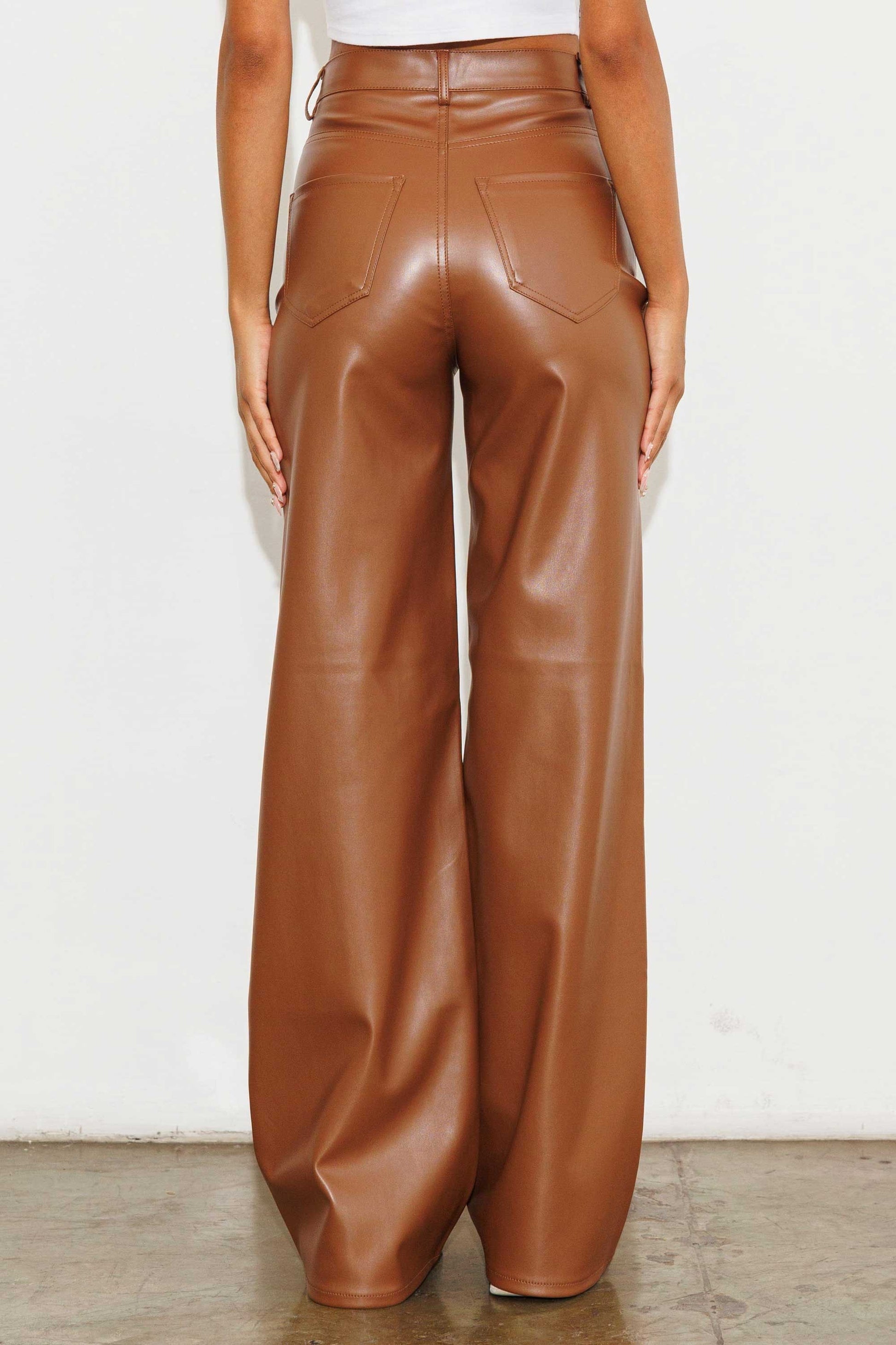 Unleash your stylish side with the Charlotte Vegan Leather Wide Leg Pants! Made from top-quality PU, these pants are both chic and ethical. With front and back pockets for convenience, plus a sleek zip-fly closure, these pants are a must-have for any fashion-forward wardrobe.  Model is 5'8" and wearing a size 3