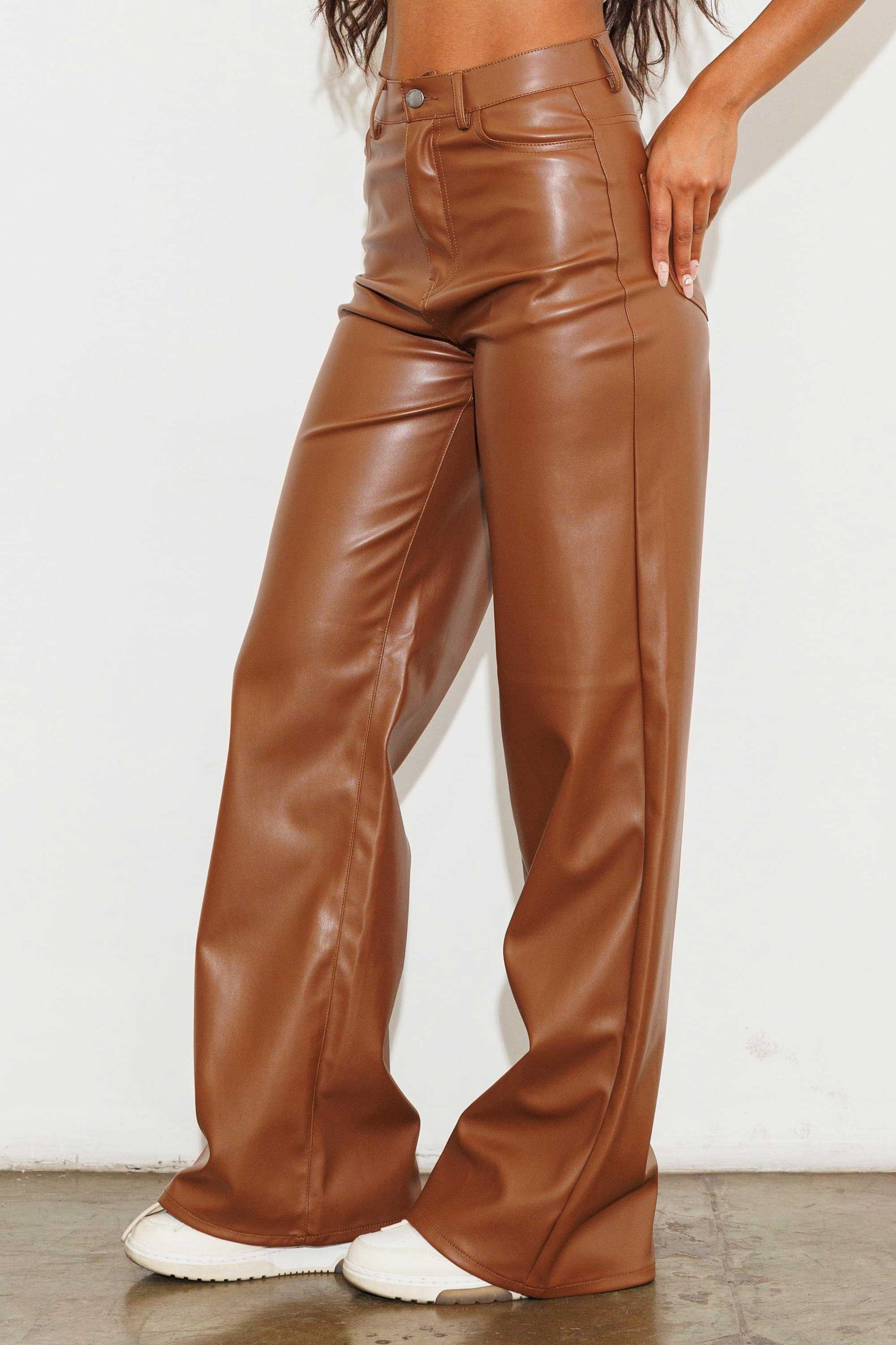 Unleash your stylish side with the Charlotte Vegan Leather Wide Leg Pants! Made from top-quality PU, these pants are both chic and ethical. With front and back pockets for convenience, plus a sleek zip-fly closure, these pants are a must-have for any fashion-forward wardrobe.  Model is 5'8" and wearing a size 3