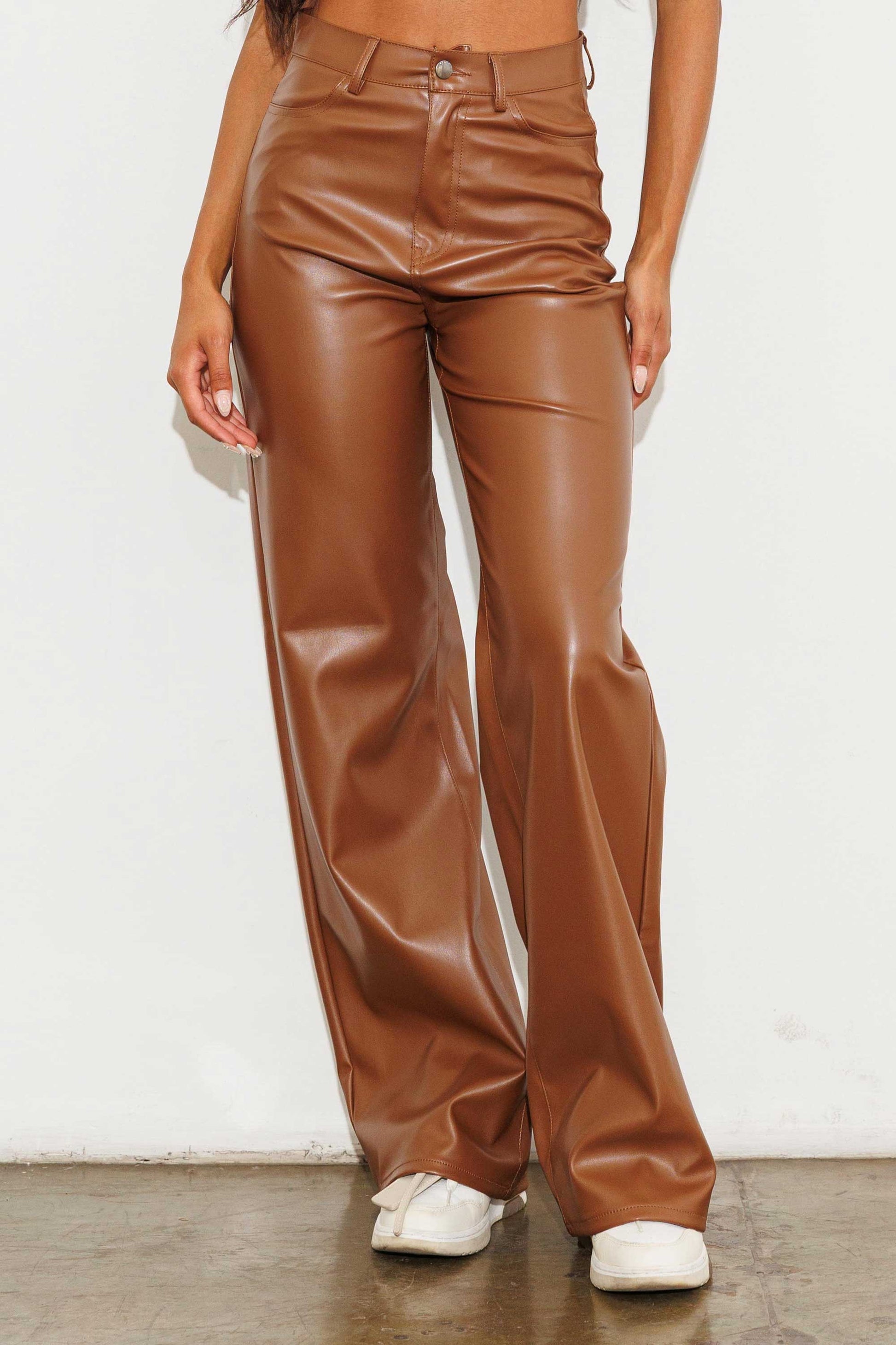 Unleash your stylish side with the Charlotte Vegan Leather Wide Leg Pants! Made from top-quality PU, these pants are both chic and ethical. With front and back pockets for convenience, plus a sleek zip-fly closure, these pants are a must-have for any fashion-forward wardrobe.  Model is 5'8" and wearing a size 3