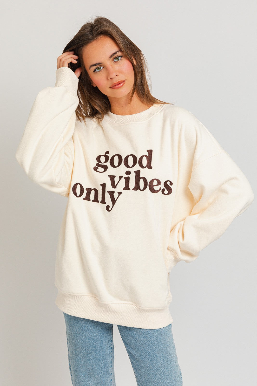 Stay warm and stylish with our oversized sweatshirt featuring embroidered letters and designs. Personalize your outfit with this cozy fashion statement.  Model is 5'8" and is wearing a size small Bust: 32A, Waist: 24", Hips: 34"