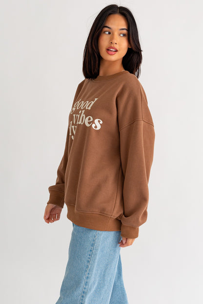 Stay warm and stylish with our oversized sweatshirt featuring embroidered letters and designs. Personalize your outfit with this cozy fashion statement.  Model is 5'8" and is wearing a size small Bust: 32A, Waist: 24", Hips: 34"