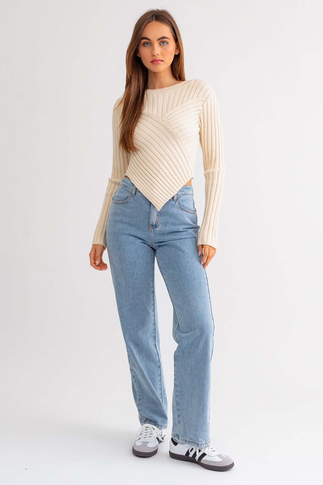 Embrace modern elegance with the Gabby Asymmetrical Hem Sweater Top. This chic and cozy piece is designed to elevate your casual style with a contemporary twist. The asymmetrical hem adds a touch of uniqueness, creating a dynamic silhouette that stands out.