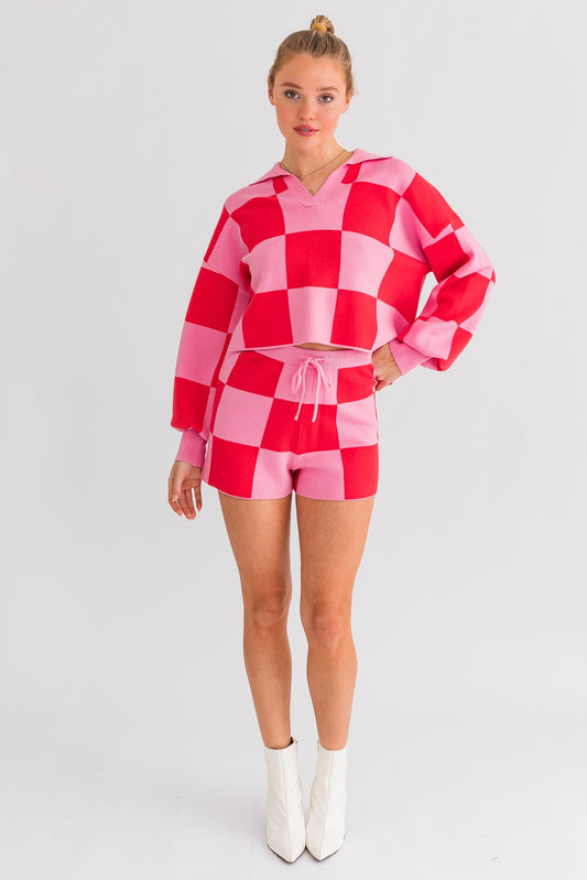 Achieve a laid-back yet stylish look with our Think Pink Checkered Sweater Shorts. The loose-fitted silhouette ensures comfort throughout your day. Paired with our matching Think Pink Checkered Sweater Top, this set exudes a relaxed and effortless style.
