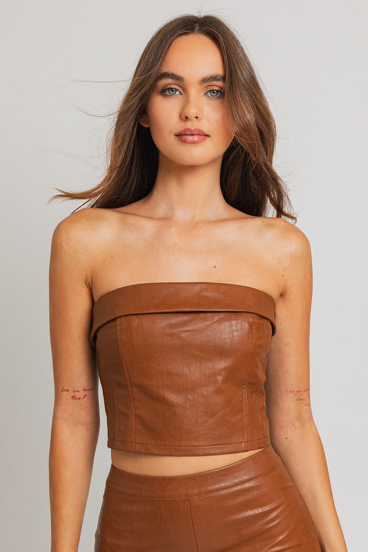 Revamp your wardrobe with our Emelie Faux Leather Corset Tube Top, a daring and chic addition to your collection. This trendy piece seamlessly combines the classic allure of a tube top with the edgy sophistication of a corset. The structured design enhances your silhouette, providing a flattering and on-trend look.