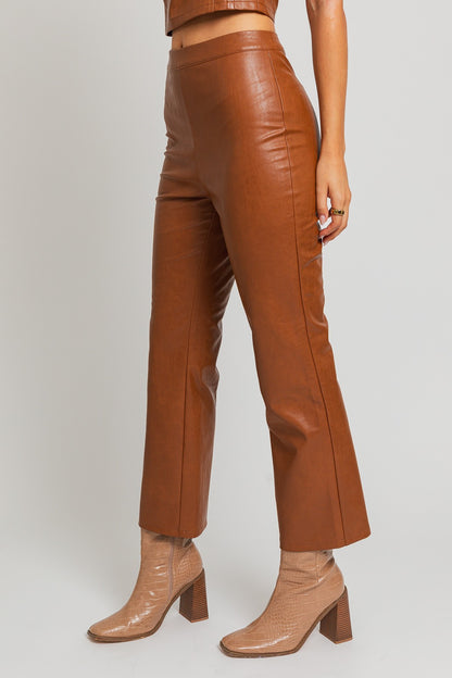 Introducing our Emelie Faux Leather Straight Pants - a versatile wardrobe staple that seamlessly combines comfort with edgy style. These pants boast a classic straight-leg silhouette, providing a flattering and polished look for any occasion.