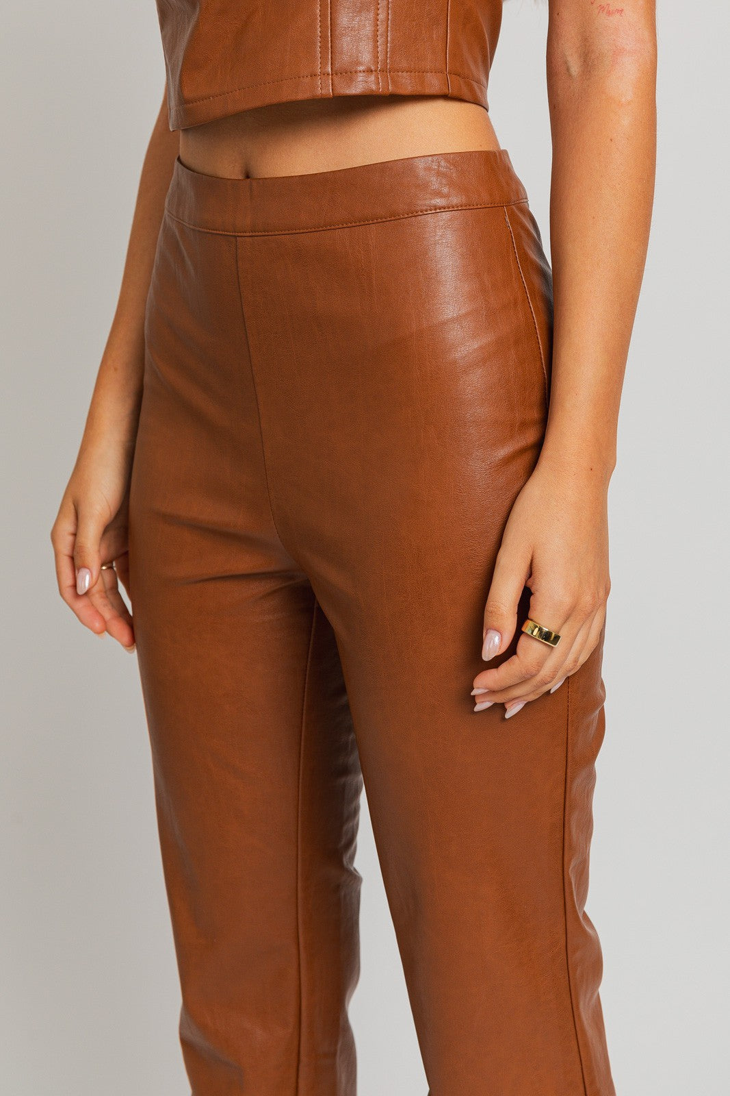 Introducing our Emelie Faux Leather Straight Pants - a versatile wardrobe staple that seamlessly combines comfort with edgy style. These pants boast a classic straight-leg silhouette, providing a flattering and polished look for any occasion.