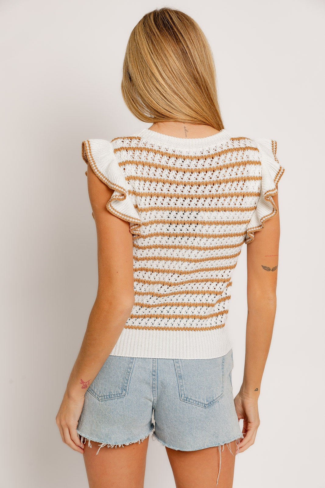 Elevate your casual look with the Penelope Ruffle Knit Top. Crafted from soft and breathable knit fabric, this top offers both comfort and style.