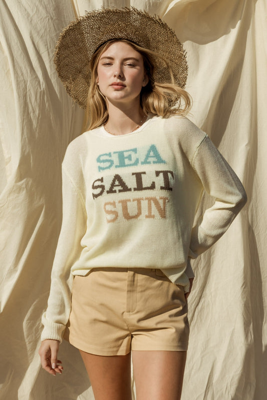Capture the essence of coastal charm with our Sea Salt Sun Sweater. This sweater exudes relaxed elegance with its round neckline and long sleeves, perfect for cool days by the sea or cozy evenings at home.