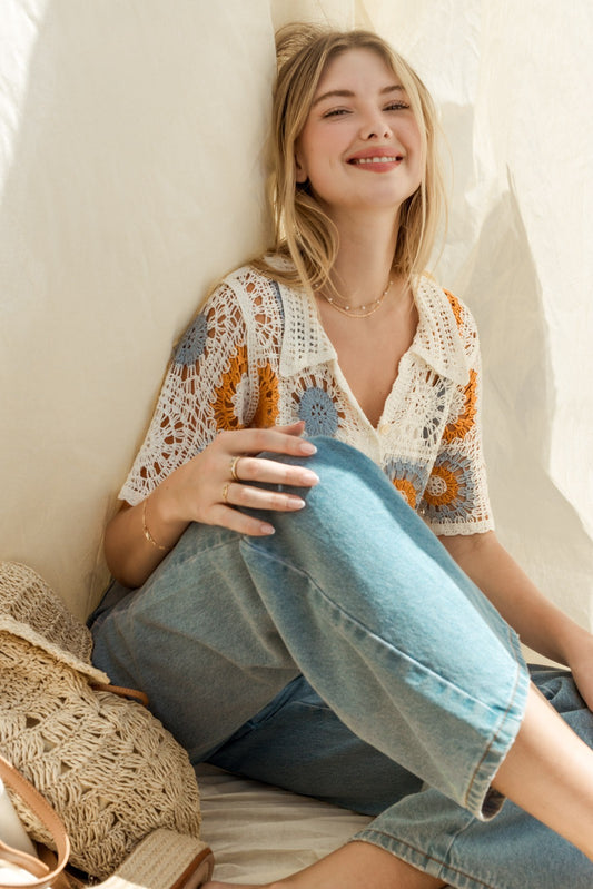 The Rosie Crochet Top is a charming addition to your wardrobe, blending elegance with a touch of bohemian flair. Featuring intricate crochet detailing and a button-down front, this top exudes vintage-inspired charm. The short sleeves add a breezy feel, perfect for warm weather days. 
