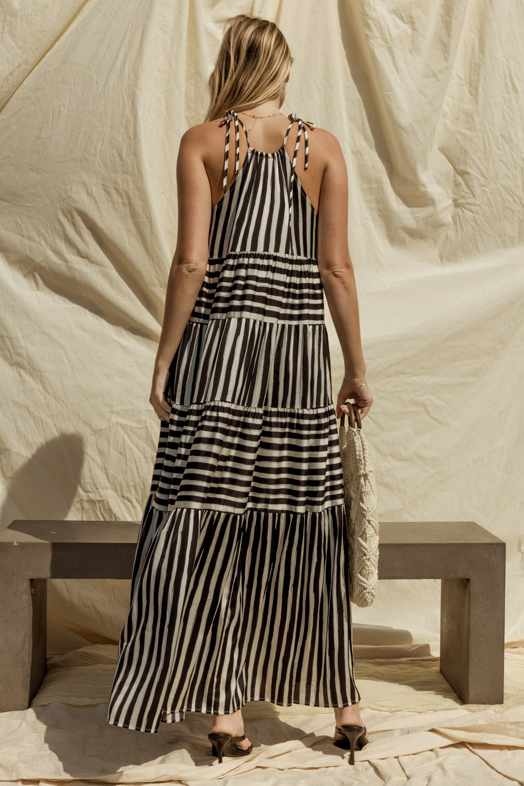 Get ready for effortless style with our Sleeveless Stripe Maxi Tiered Dress! This dress exudes laid-back elegance with its sleeveless design and tiered silhouette, offering a relaxed yet flattering fit for any body type.