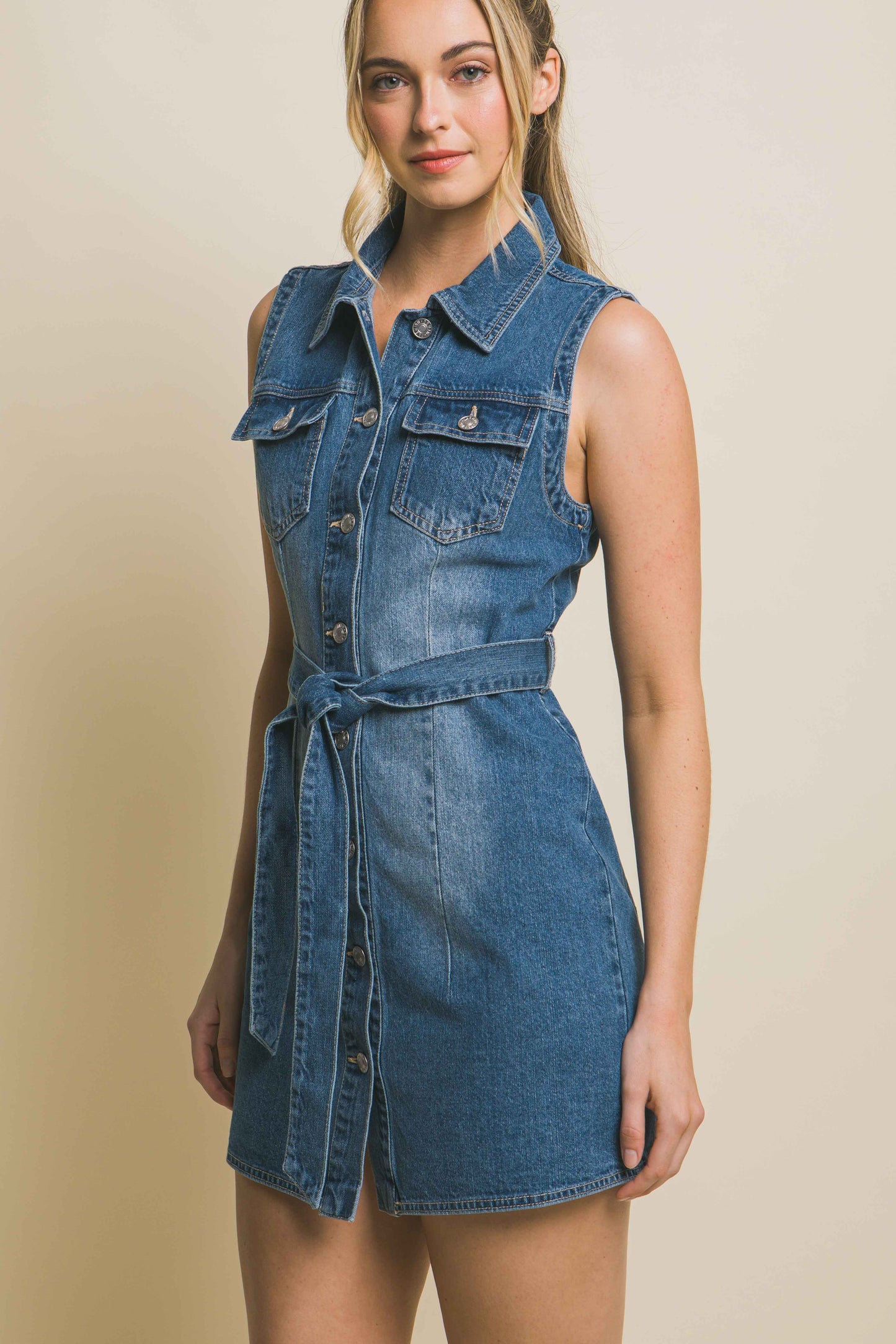 The Julia Denim Dress With Waist Tie is crafted from durable denim fabric. The waist tie detail adds definition and allows you to cinch the dress for a flattering silhouette.