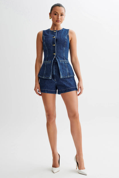 The Gianna Denim Two Piece Set combines stylish denim vest and shorts, designed with a round neck and sleeveless cut for a chic finish that will elevate your summer wardrobe.