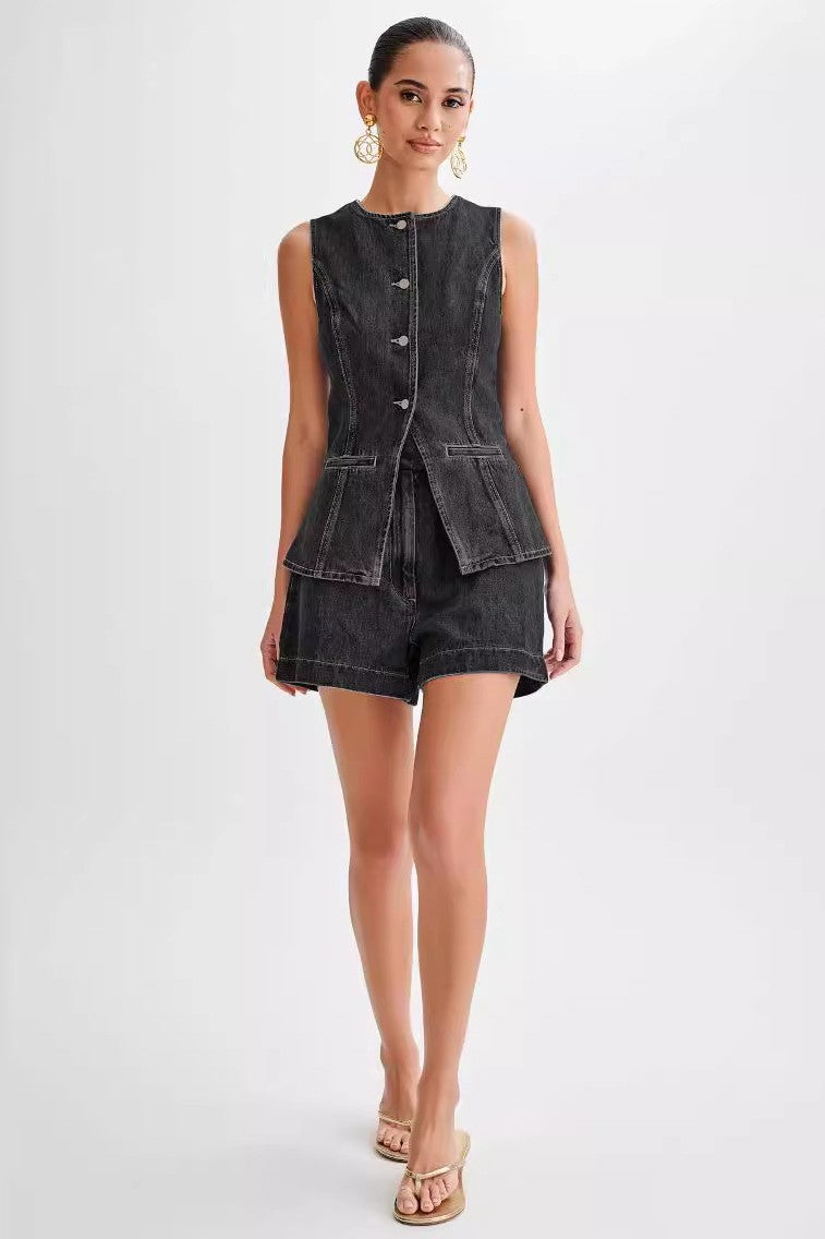 The Gianna Denim Two Piece Set combines stylish denim vest and shorts, designed with a round neck and sleeveless cut for a chic finish that will elevate your summer wardrobe.