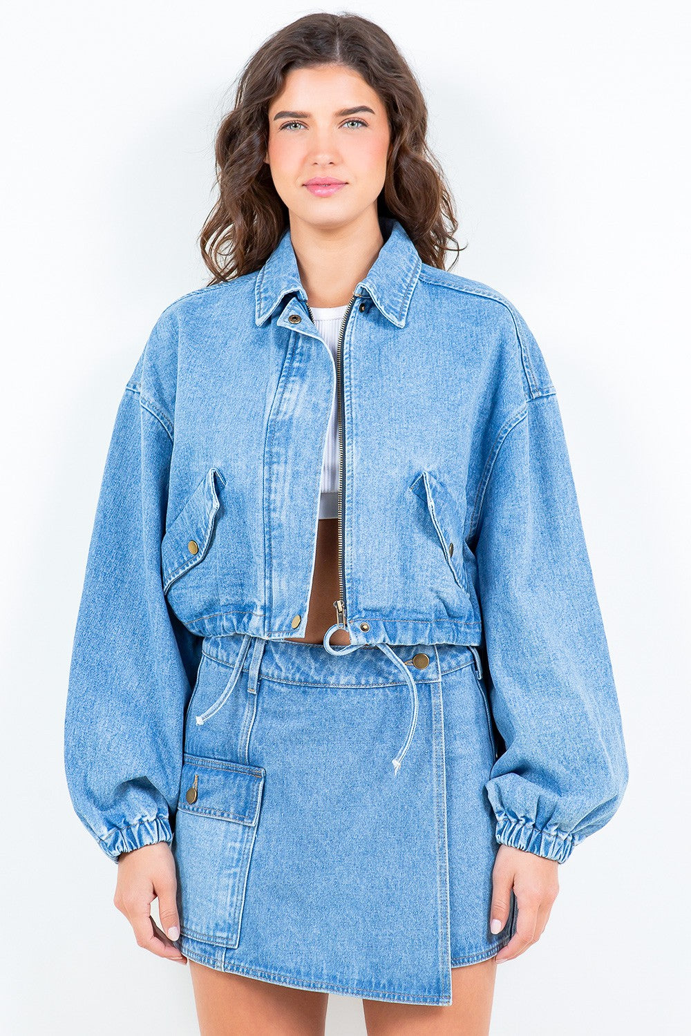 The perfect blend of style and comfort, this denim jacket features a drawstring waist, cropped length, zipper closure, and elastic hem and cuffs. Adjust the waist for a flattering fit and stay effortlessly chic with this versatile and functional Nora Denim Jacket.