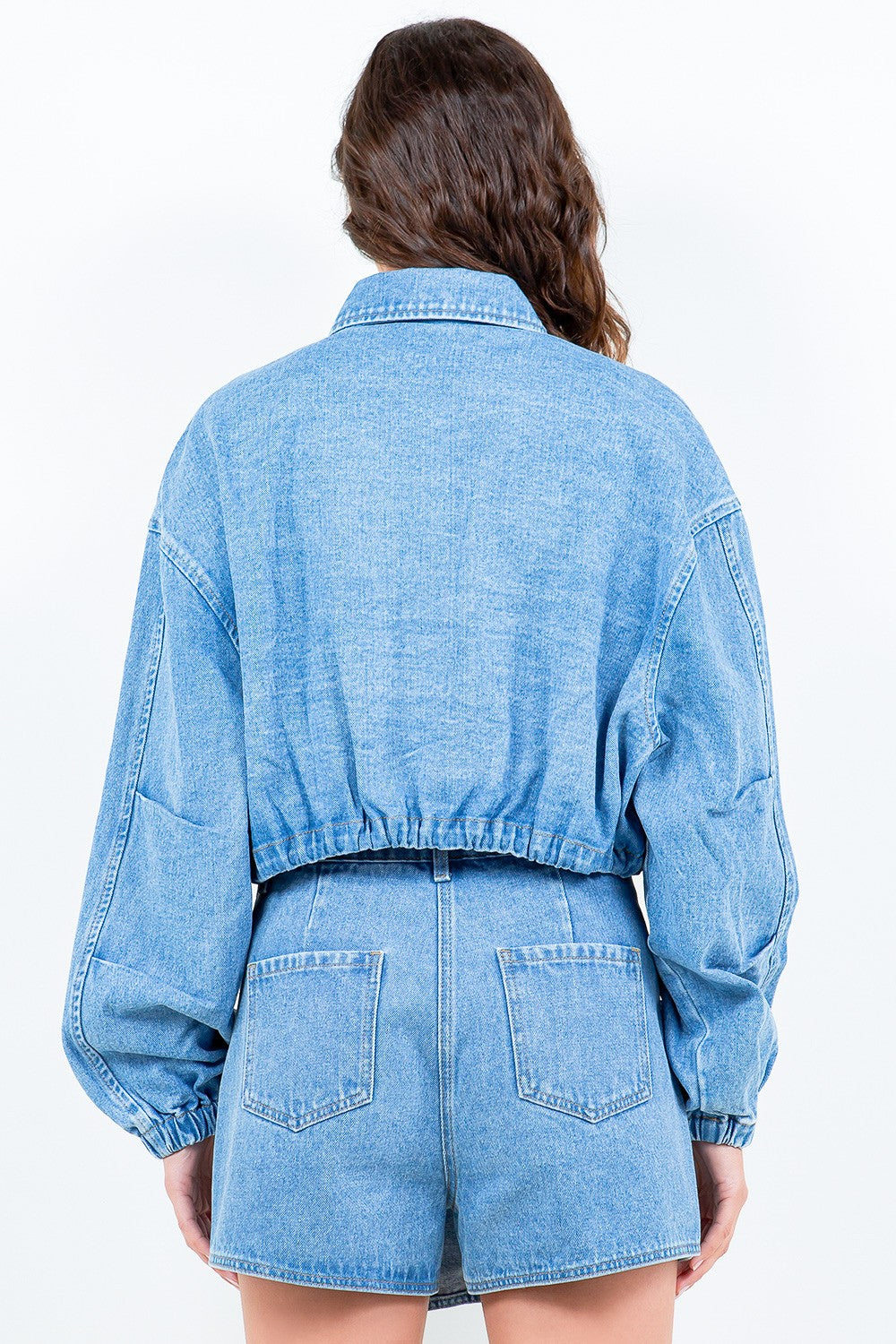 The perfect blend of style and comfort, this denim jacket features a drawstring waist, cropped length, zipper closure, and elastic hem and cuffs. Adjust the waist for a flattering fit and stay effortlessly chic with this versatile and functional Nora Denim Jacket.