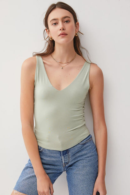 Introducing the Olivia V-Neck Tank. Made from high-quality fabric, it offers a soft and breathable feel for all-day wear. The classic design makes it a perfect staple piece in your wardrobe. Elevate your look with this stylish tank top that can be dressed up or down effortlessly!