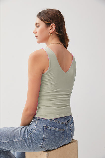 Introducing the Olivia V-Neck Tank. Made from high-quality fabric, it offers a soft and breathable feel for all-day wear. The classic design makes it a perfect staple piece in your wardrobe. Elevate your look with this stylish tank top that can be dressed up or down effortlessly!