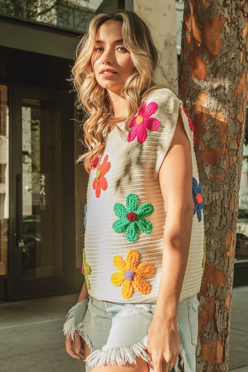 The Maia Flower Knit Top is fun and versatile, with a whimsical floral pattern and flattering round neckline. Pair it with jeans or a skirt for a chic and stylish look.