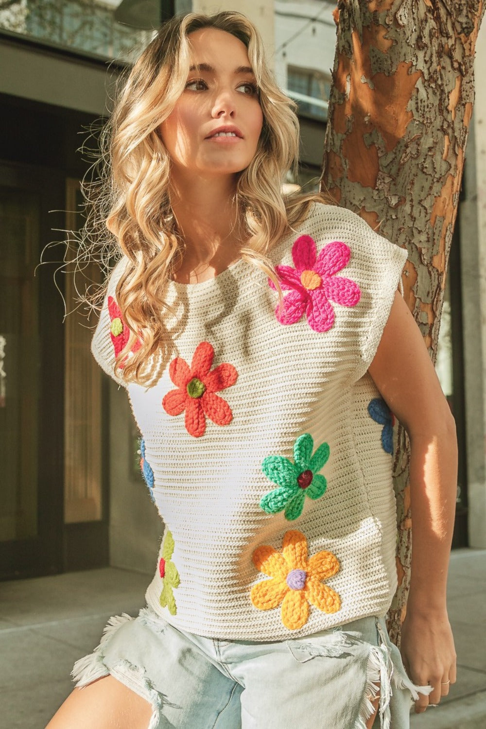 The Maia Flower Knit Top is fun and versatile, with a whimsical floral pattern and flattering round neckline. Pair it with jeans or a skirt for a chic and stylish look.