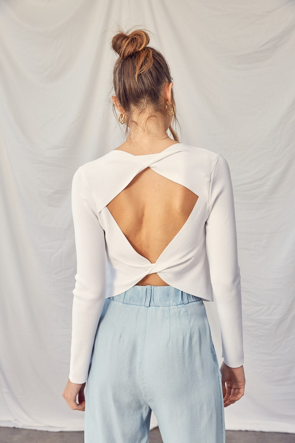 The Ivy Twisted Backless Top is a chic piece that is perfect for adding a touch of style to your wardrobe. Pair this top with high-waisted pants or a skirt for a fashionable and sophisticated look.