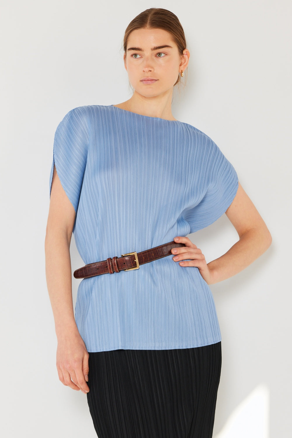 This oversized dolman sleeve top is a trendy and chic choice for a relaxed and stylish look. The ribbed texture adds dimension and the pleats add sophistication to the design. Dress it up with tailored pants or down with denim for any occasion.