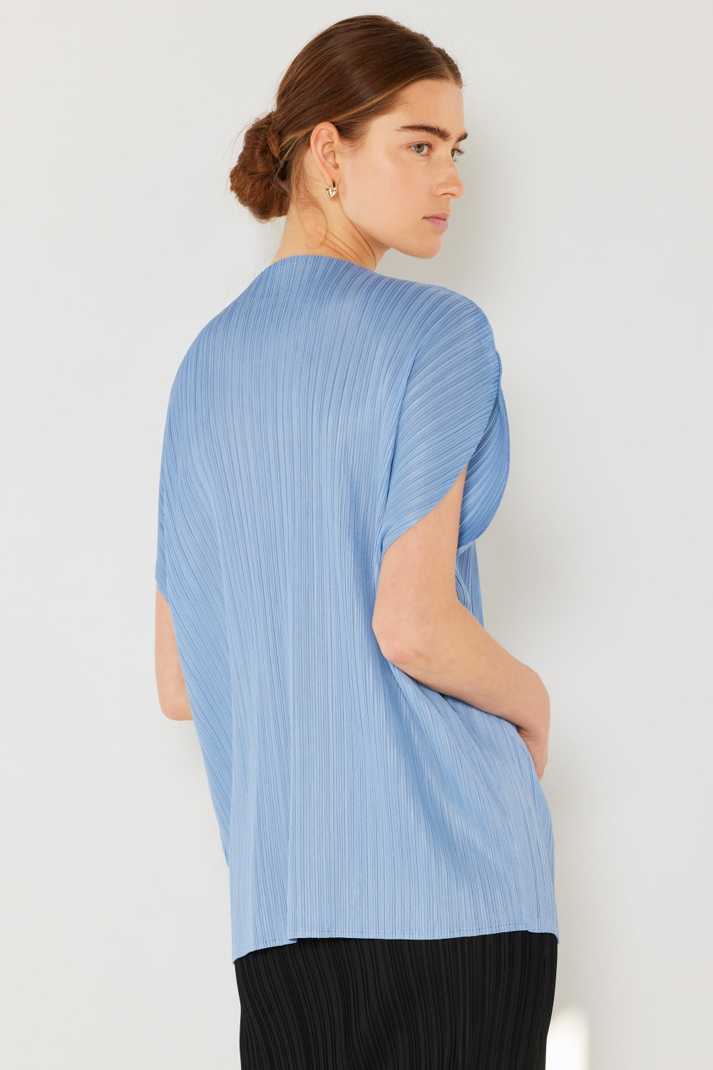 This oversized dolman sleeve top is a trendy and chic choice for a relaxed and stylish look. The ribbed texture adds dimension and the pleats add sophistication to the design. Dress it up with tailored pants or down with denim for any occasion.