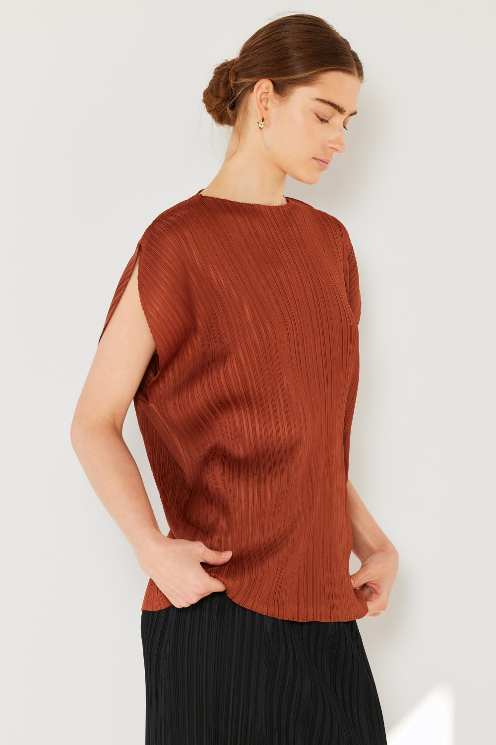 This oversized dolman sleeve top is a trendy and chic choice for a relaxed and stylish look. The ribbed texture adds dimension and the pleats add sophistication to the design. Dress it up with tailored pants or down with denim for any occasion.