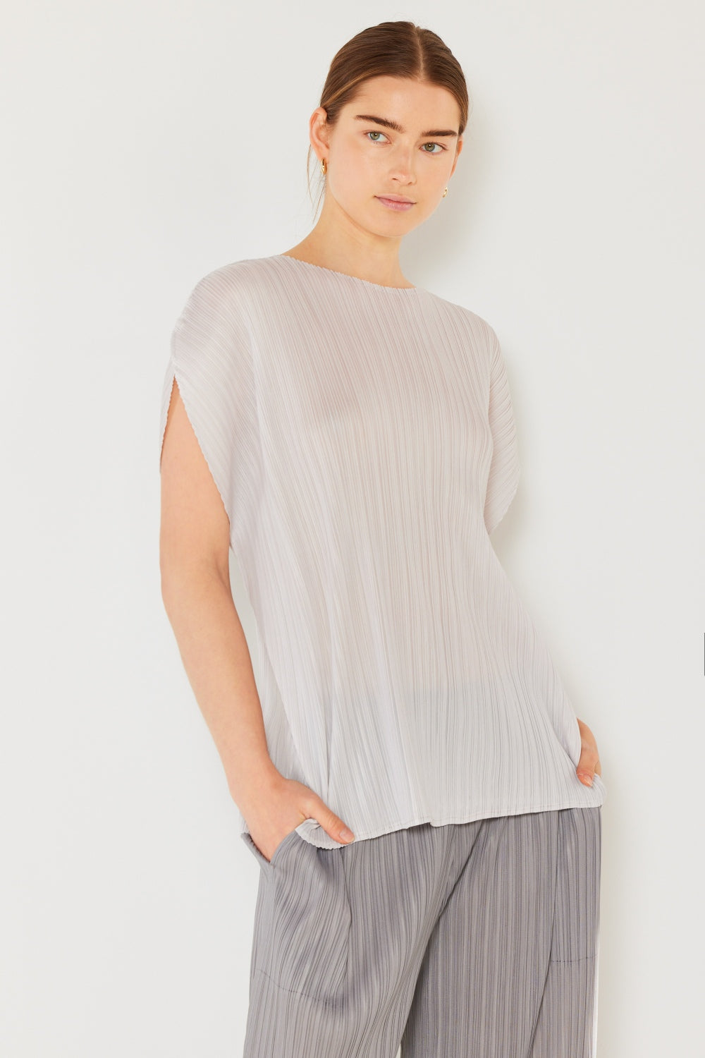 This oversized dolman sleeve top is a trendy and chic choice for a relaxed and stylish look. The ribbed texture adds dimension and the pleats add sophistication to the design. Dress it up with tailored pants or down with denim for any occasion.