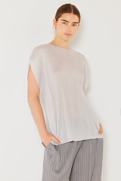 This oversized dolman sleeve top is a trendy and chic choice for a relaxed and stylish look. The ribbed texture adds dimension and the pleats add sophistication to the design. Dress it up with tailored pants or down with denim for any occasion.