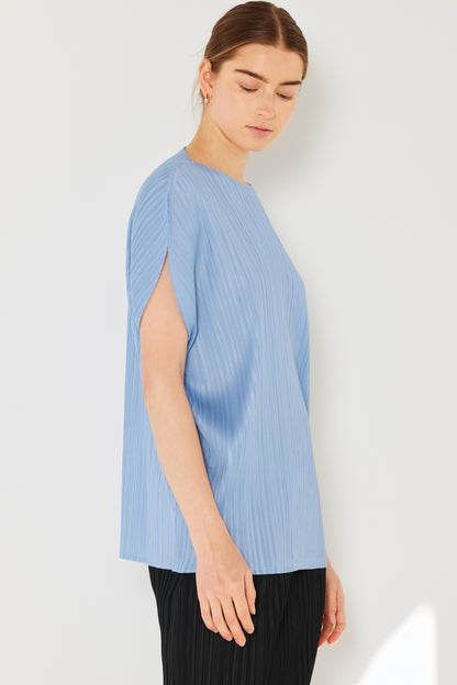 This oversized dolman sleeve top is a trendy and chic choice for a relaxed and stylish look. The ribbed texture adds dimension and the pleats add sophistication to the design. Dress it up with tailored pants or down with denim for any occasion.