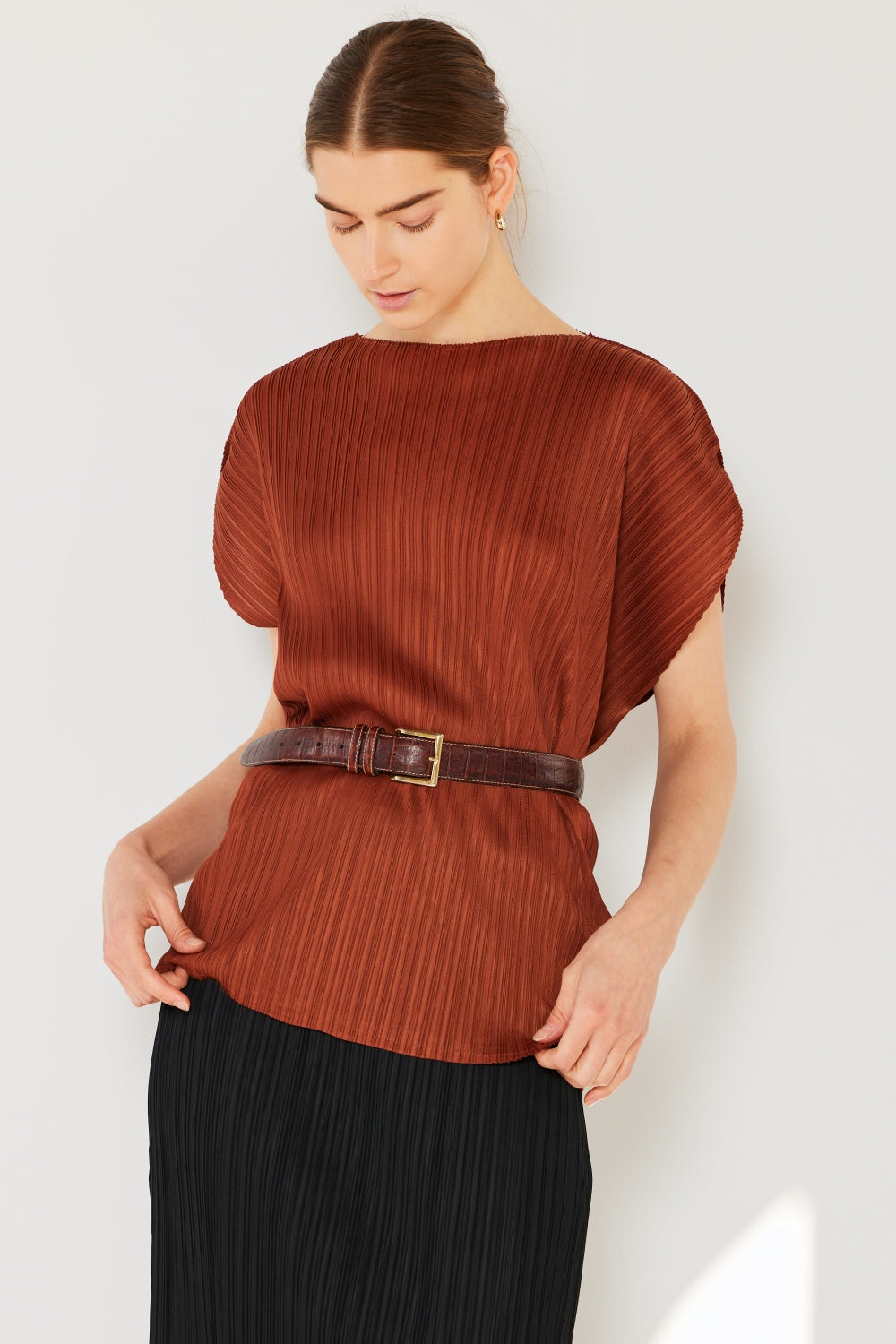 This oversized dolman sleeve top is a trendy and chic choice for a relaxed and stylish look. The ribbed texture adds dimension and the pleats add sophistication to the design. Dress it up with tailored pants or down with denim for any occasion.